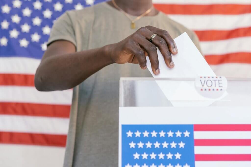Man putting his vote on ballot box