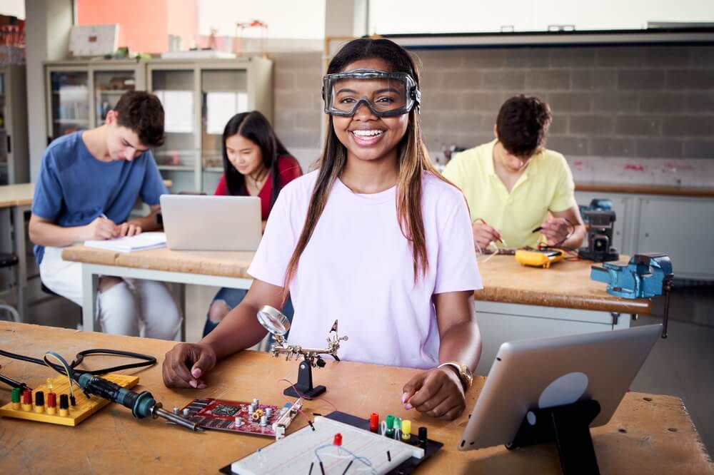Young student wearing safety goggles in technical vocational training college