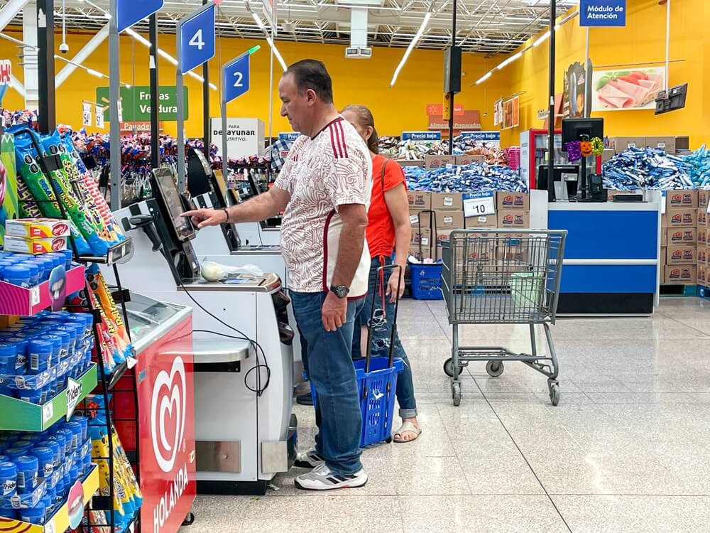 Customers paying at self-service checkout
