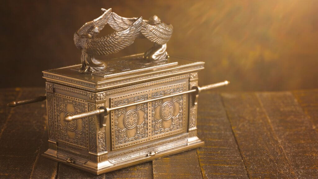 Artistic depiction of the Ark of the Covenant illuminated by dramatic sunlight inside an ancient setting