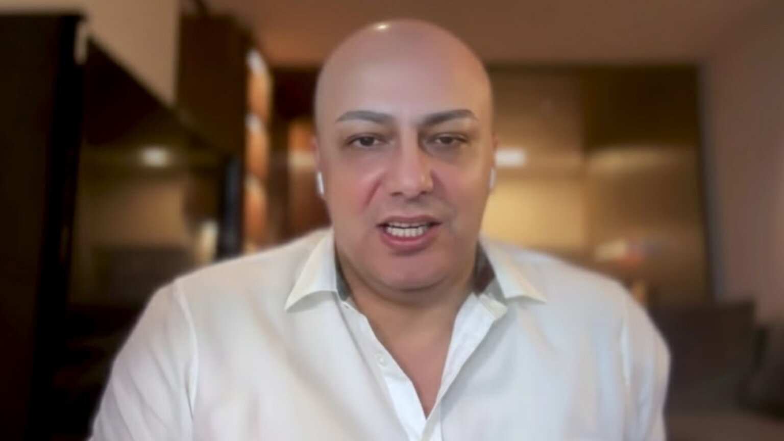Jad Tarifi speaking during a video interview from a home office setting.