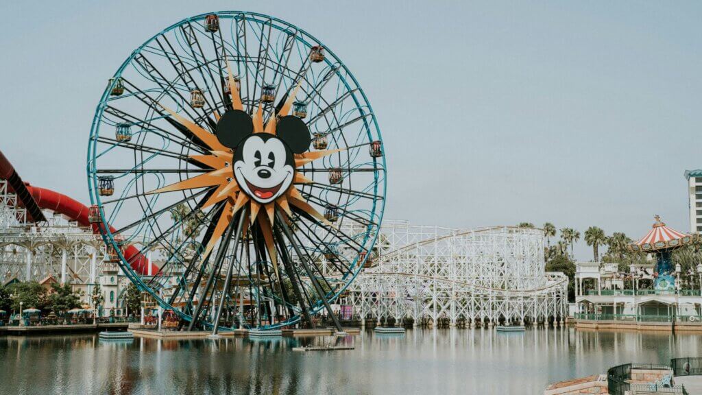 Ferris wheel beside a body of water during daytime at an amusement park