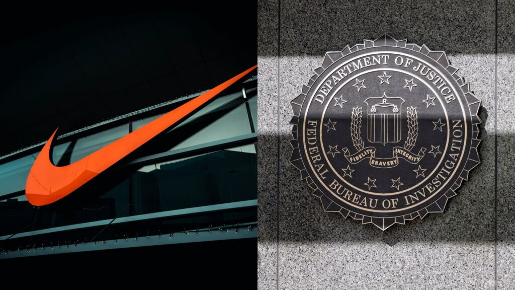 Large orange Nike logo mounted on the exterior of a commercial building