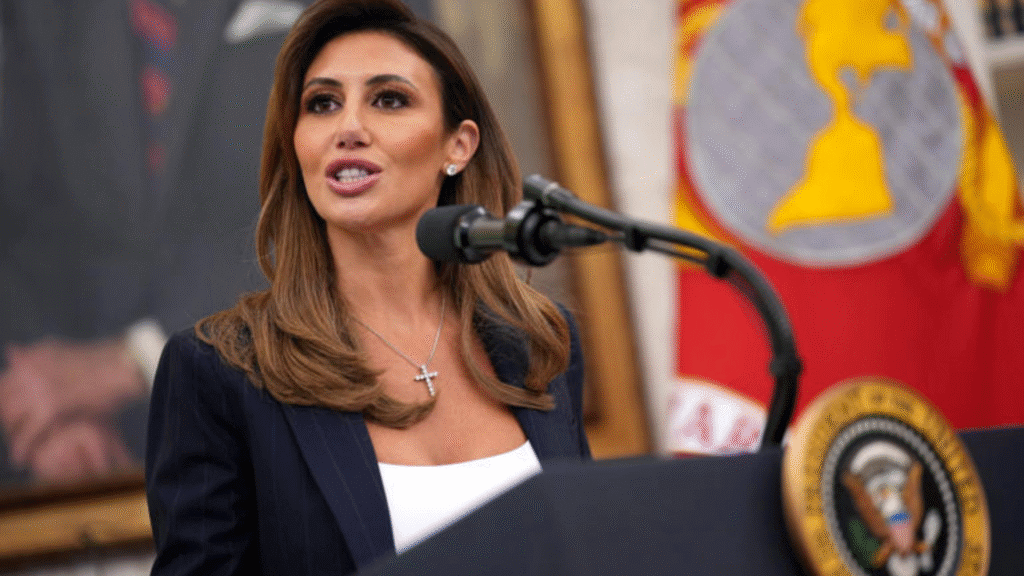 Woman speaking at a podium with the presidential seal, national flag in the background.