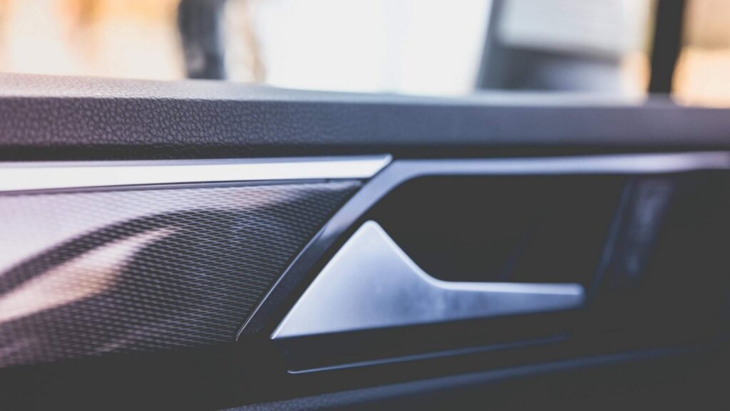 Close-up of a car door interior showing texture and design elements.