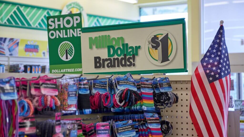 Dollar Tree store display featuring a sign that reads Million Dollar Brands and Shop Online at Dollartree.com above racks of colorful hair accessories.