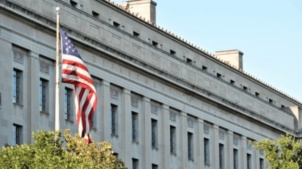 U.S. flag displayed outside the Department of Justice building.