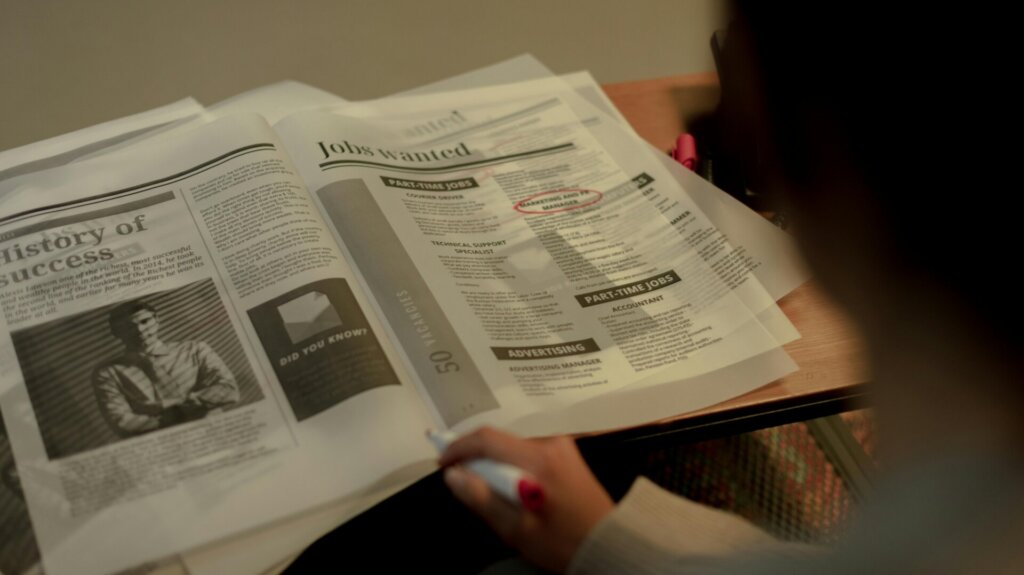 A Person looking at a newspaper.