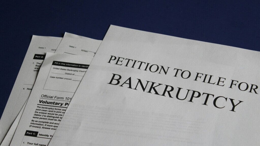 Bankruptcy petition paperwork laid out on a desk