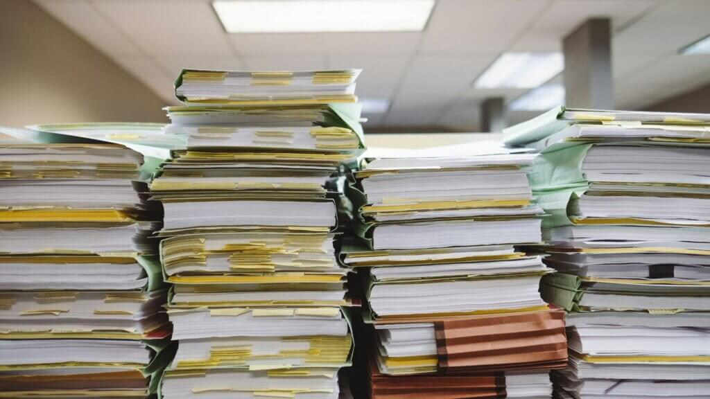 Stack of books arranged on a table representing records and documentation