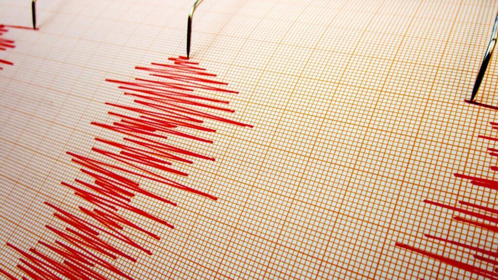 Seismograph machine recording earthquake activity on paper