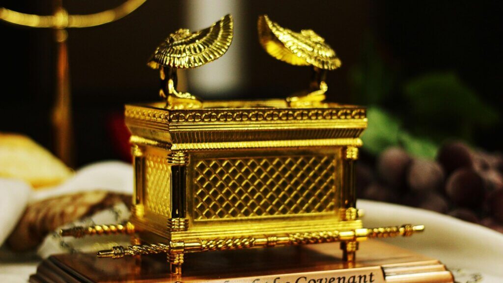 Artistic representation of the Ark of the Covenant featuring gold overlay and ornate details