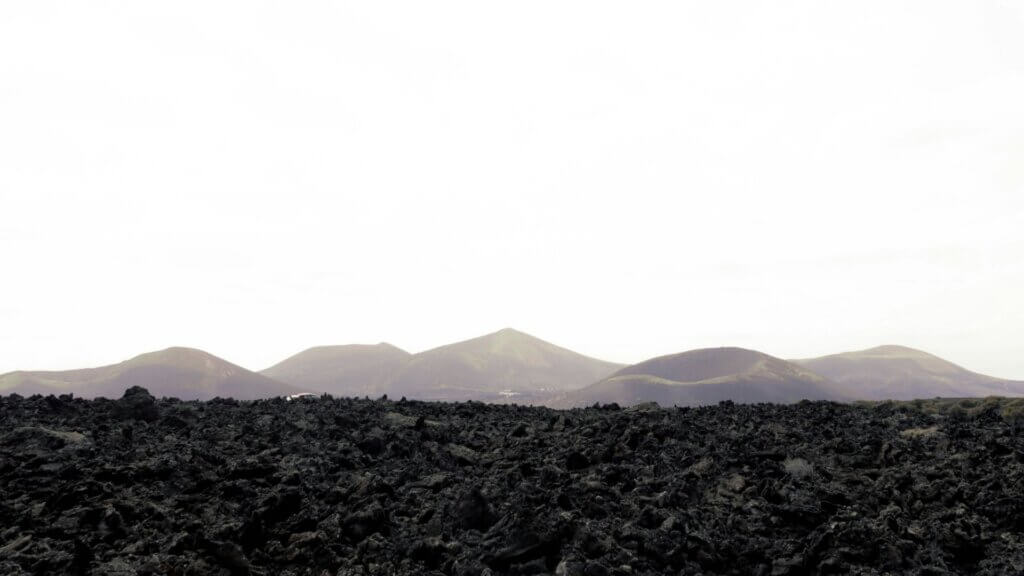 Mountain pass under bright sky with layered rock formations