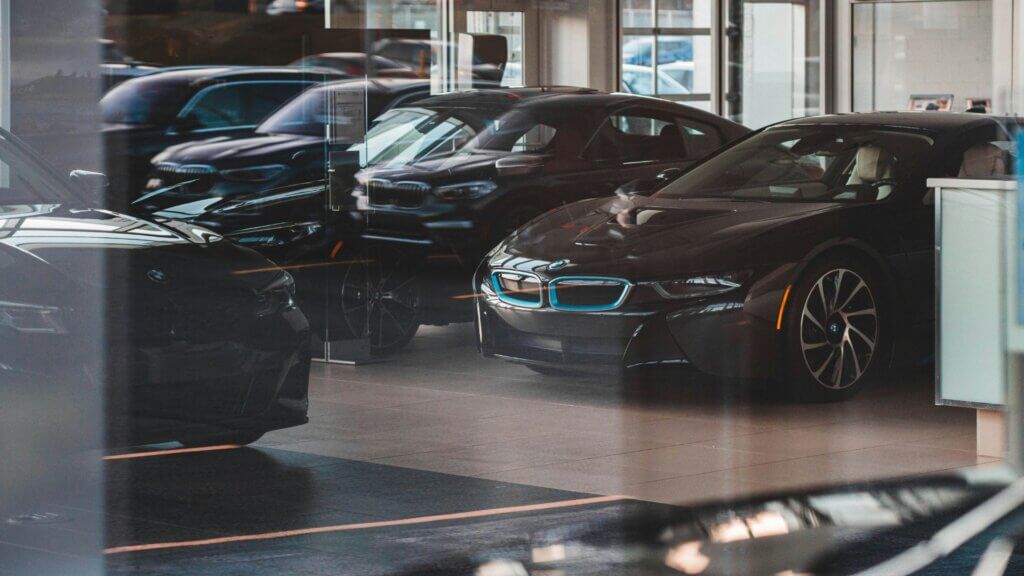 Rows of black cars parked closely together in a parking lot