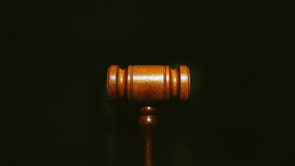 Wooden legal podium stand against a dark background