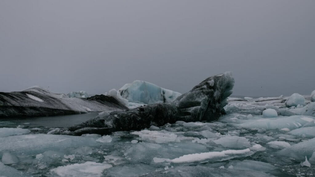 Ice at lake with a dark gray residue