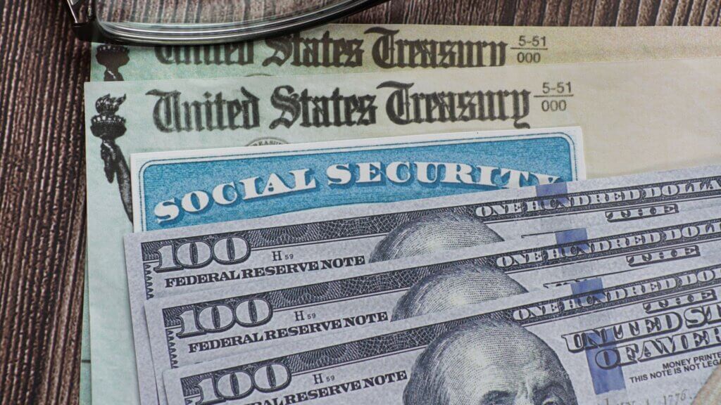Social security card, US currency and treasury department checks