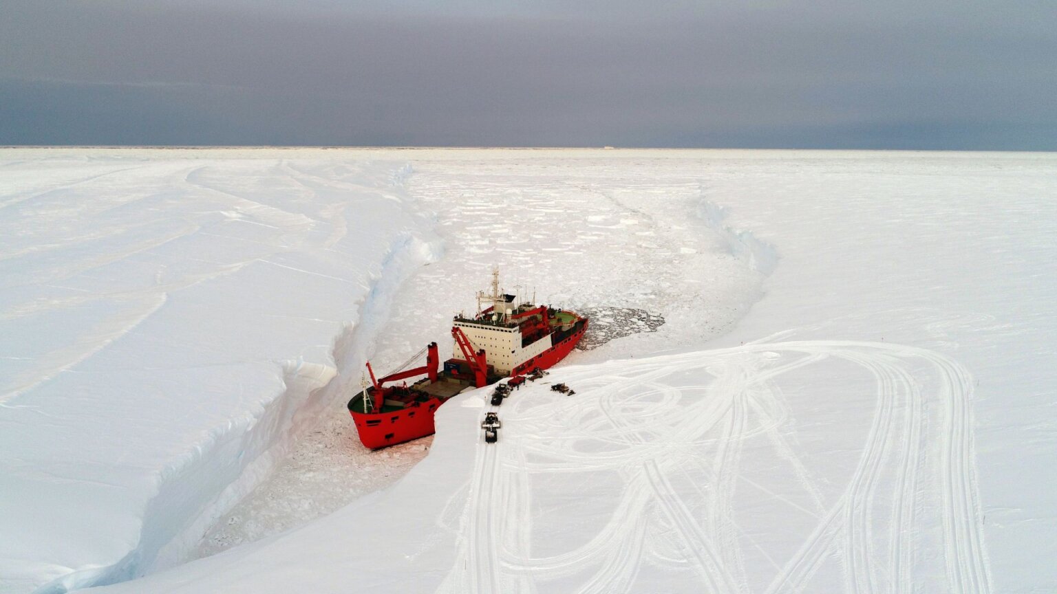 A cargo ship arrives in port for unloading on an ice floe in the Antarctic
