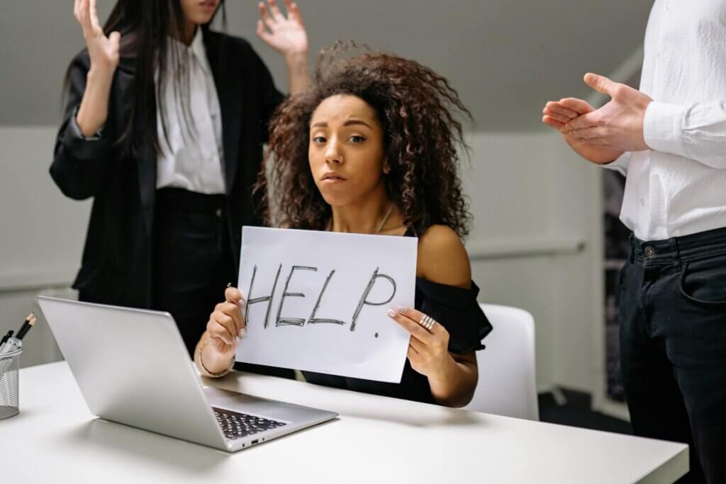A woman holding a sign that reads HELP