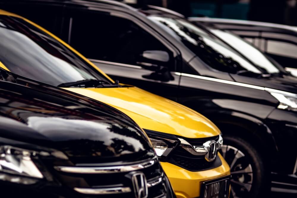 Honda vehicles parked side by side at a dealership lot.