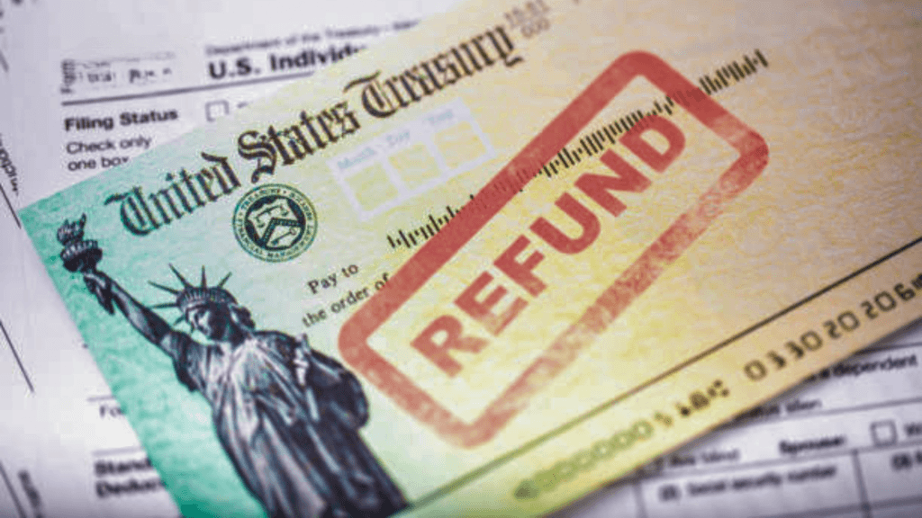 Close-up of an official United States Treasury tax refund check resting on top of a tax return document.
