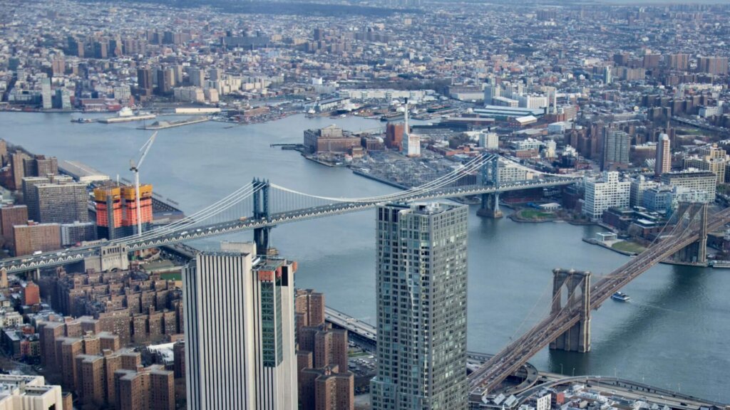 Aerial view of a dense metropolitan area with clusters of high-rise buildings.