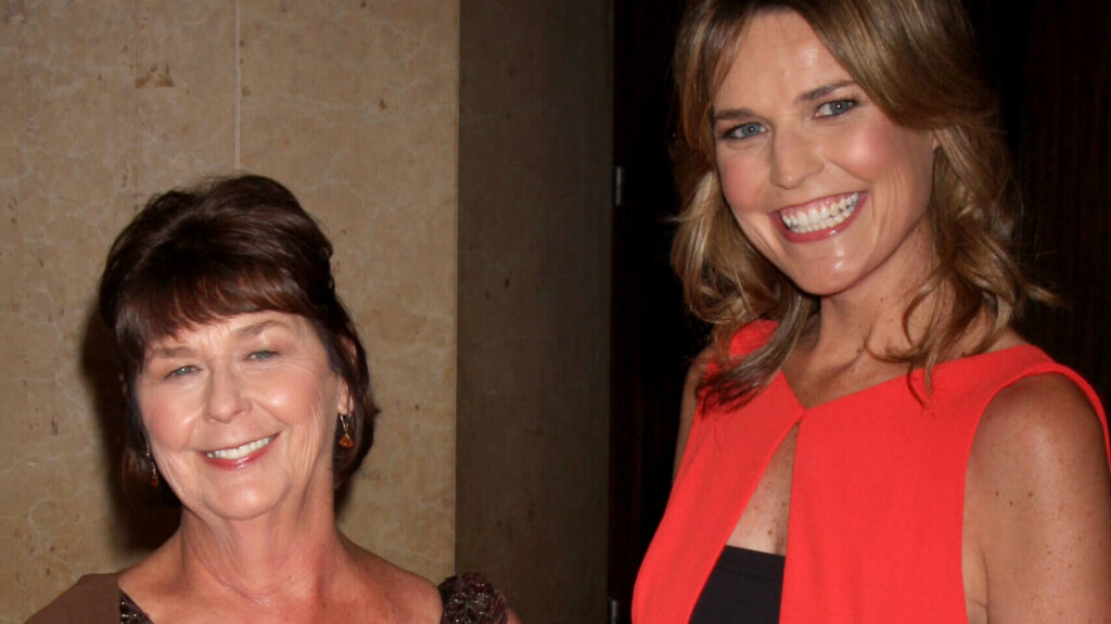 Two women posing together at an indoor event.