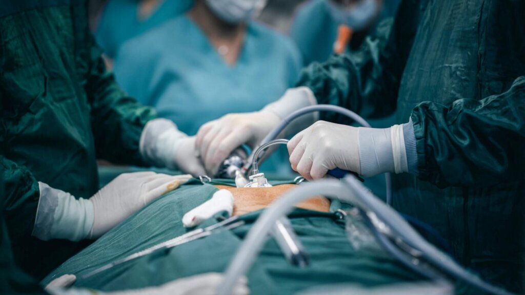 Surgeons performing a surgical procedure in an operating room.