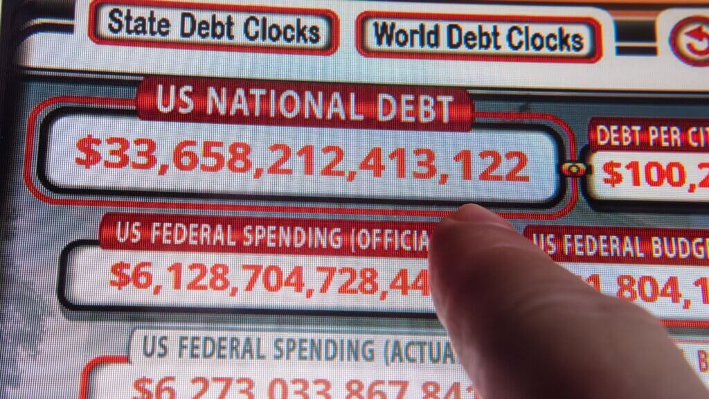 Close-up of the US national debt clock displaying a debt total on a digital screen.
