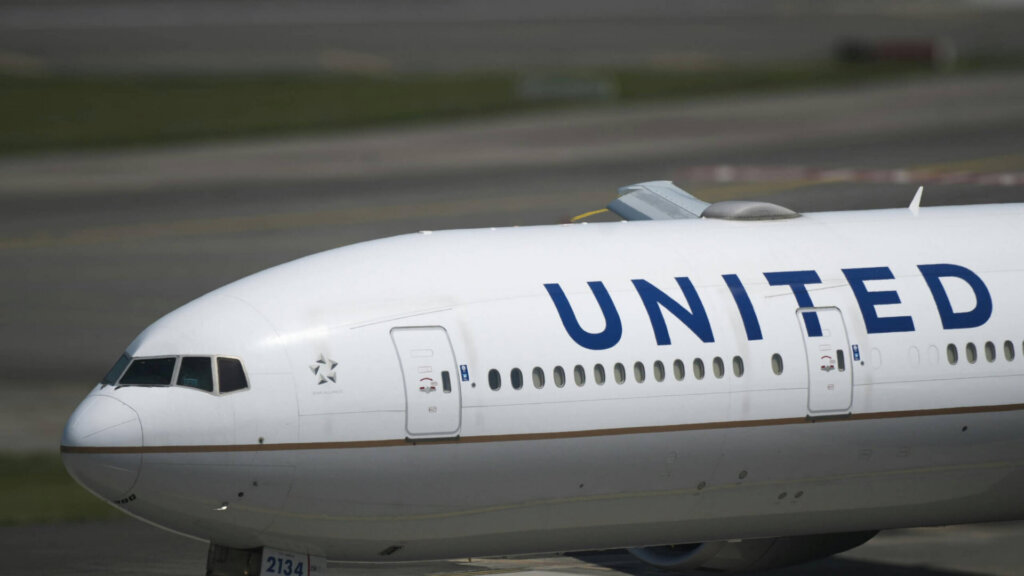 United Airlines aircraft taxiing on the runway at an airport.
