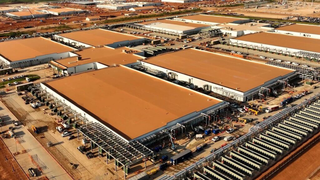 Aerial view of a large industrial data center campus under construction.