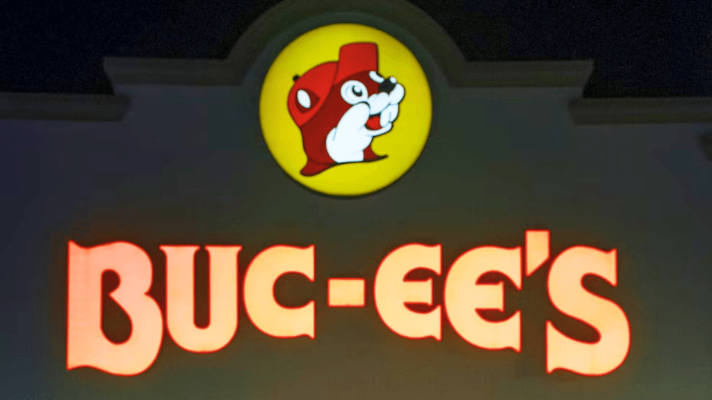 A bright red Buc-ee's sign with a beaver logo shines in the dark.