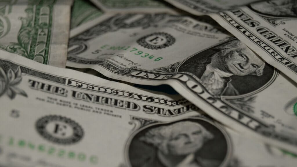 Close view of a document with a pen resting beside printed text representing legal or employment paperwork