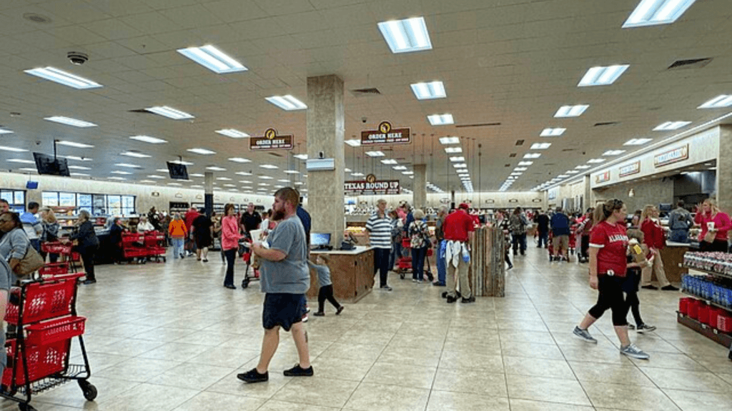 Many people walk around and shop inside a very large Buc-ee's store.