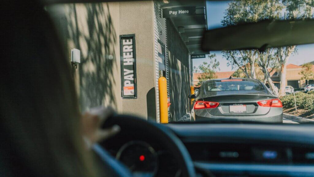 A person in a car going through a drive thru.