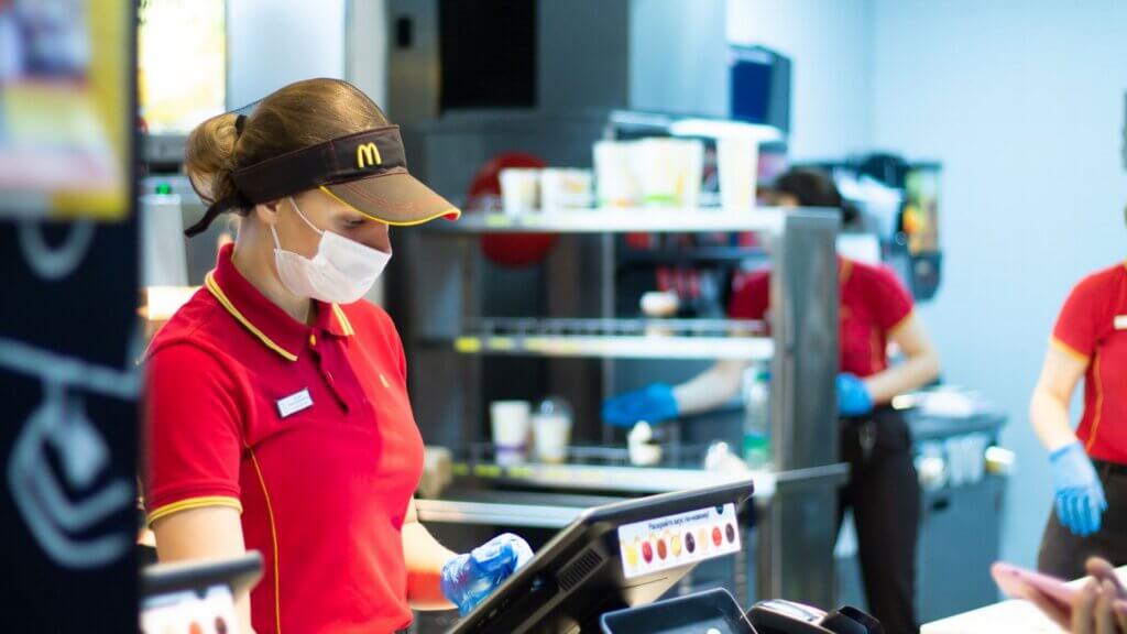 Close up of a McDonald's employee at the cash register.