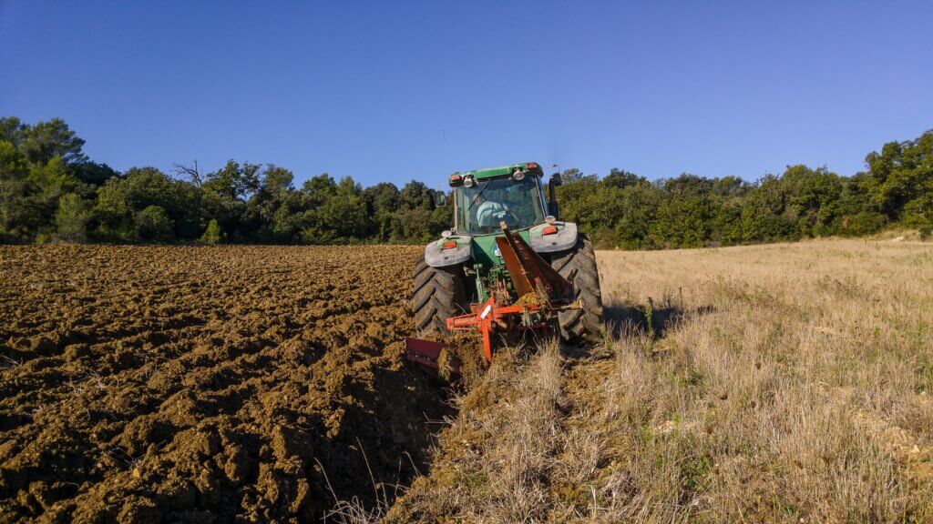 Agricultural activities and a machine in a land.