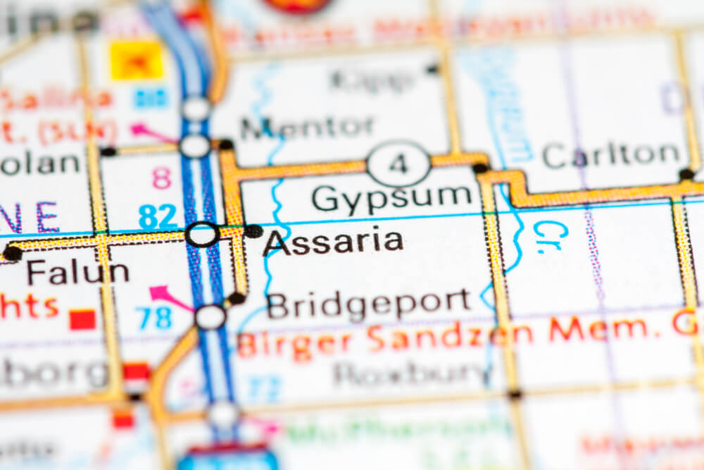 Close-up of a road map highlighting Assaria and Gypsum in Kansas with nearby towns and highways labeled.