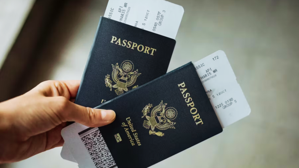 Hand holding two United States passports with boarding passes visible.