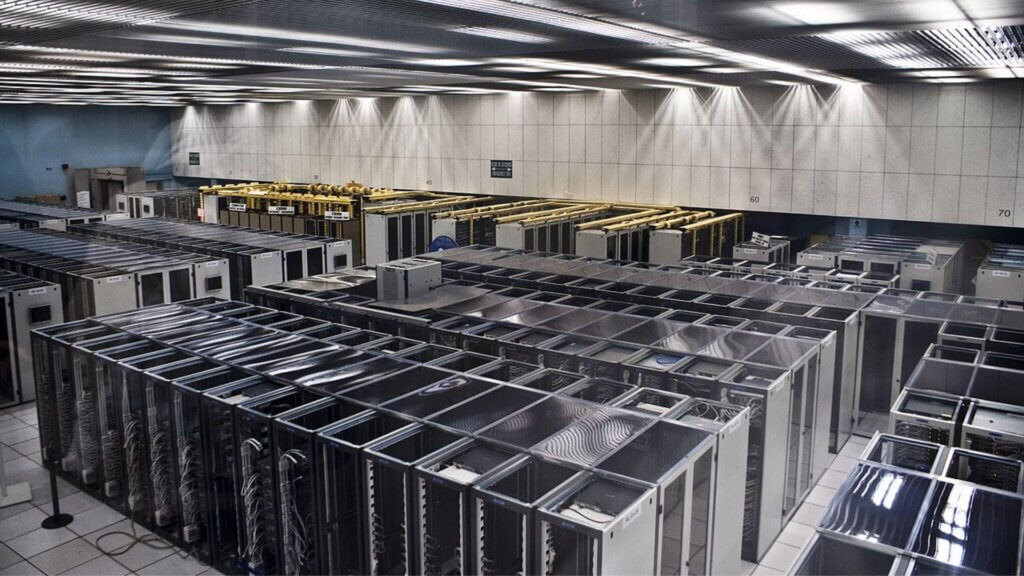 Rows of server racks inside a data center, illustrating Oracle's cloud and AI infrastructure.