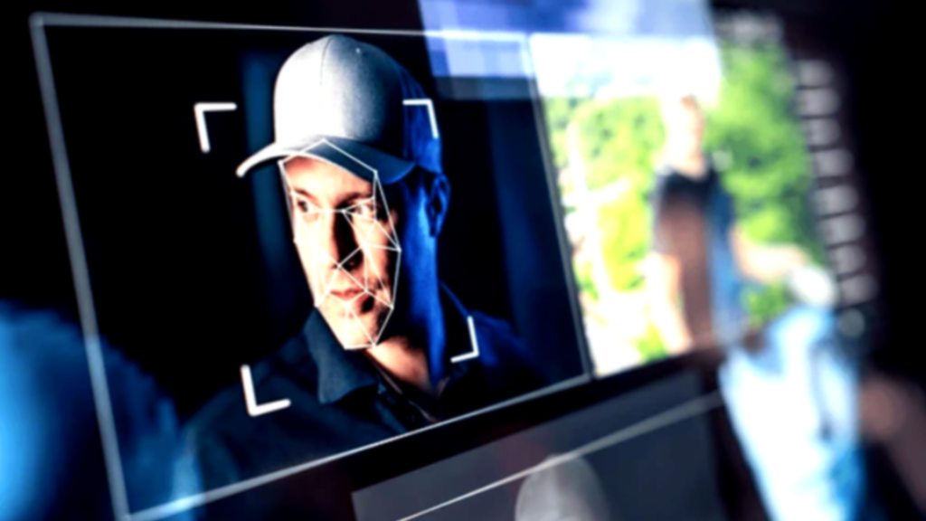 A close-up of a digital screen showing a man’s face being scanned by a facial recognition system.