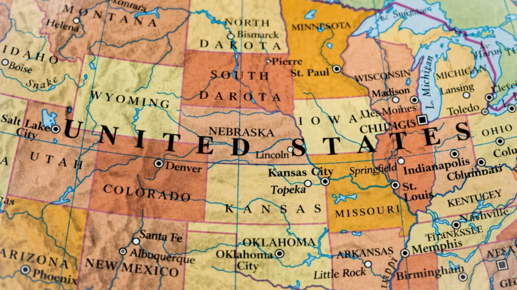 A close-up, slightly tilted top-down shot of a colorful map of the United States.