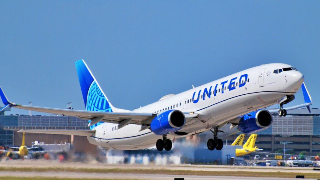 United Airlines plane taking off from runway at airport.