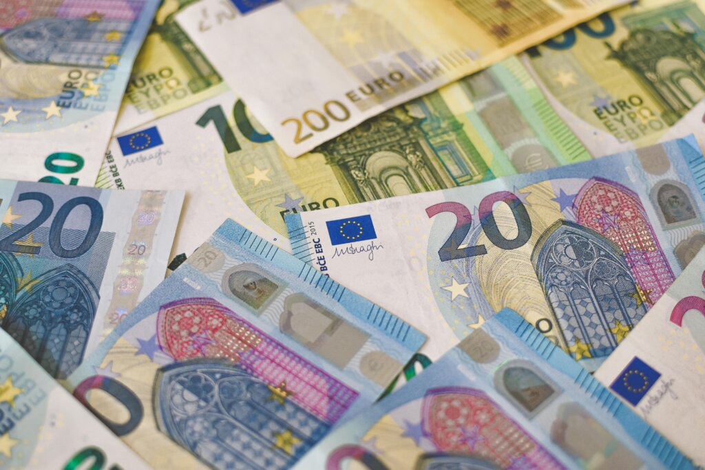 Euro banknotes in various denominations spread out in a close-up view.