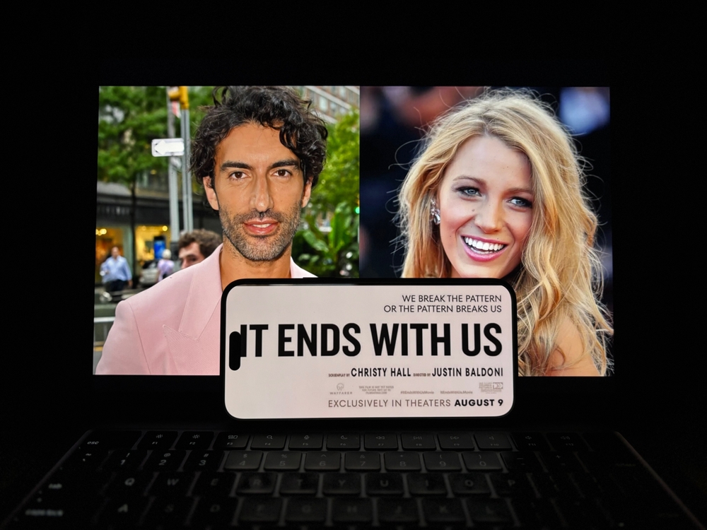 Justin Baldoni and Blake Lively shown alongside an "It Ends With Us" film title graphic on a laptop screen.