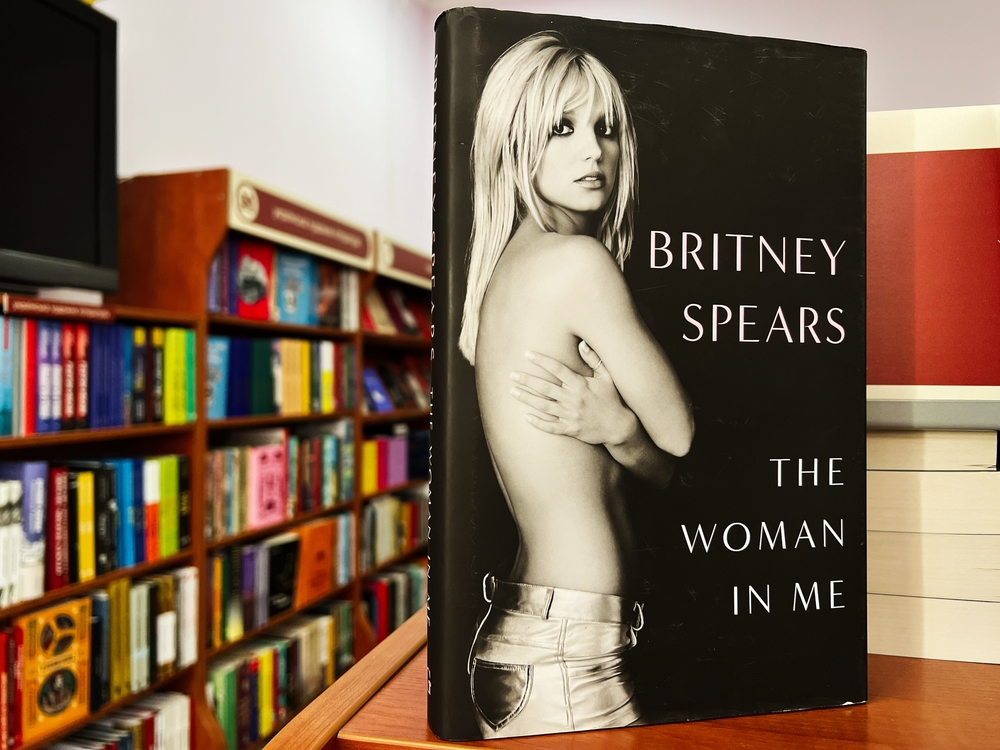 Britney Spears’ memoir “The Woman in Me” displayed upright on a table in a bookstore.