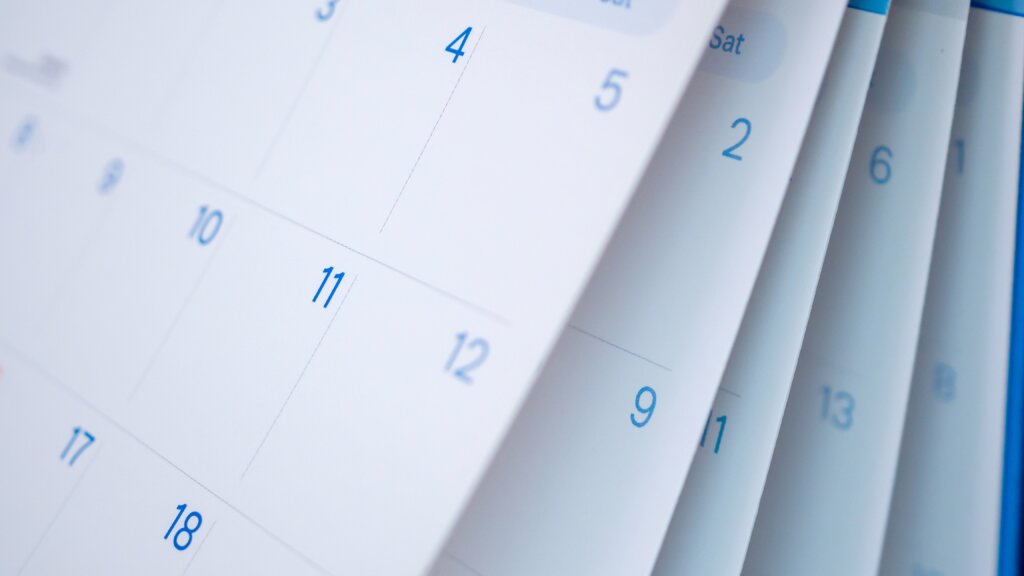 Close-up of calendar pages with dates visible, emphasizing a mid-month schedule.