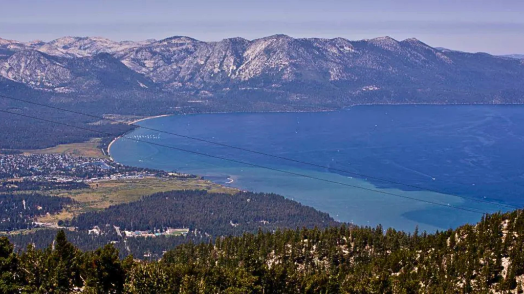 Lake Tahoe shoreline with forested mountains in the background.