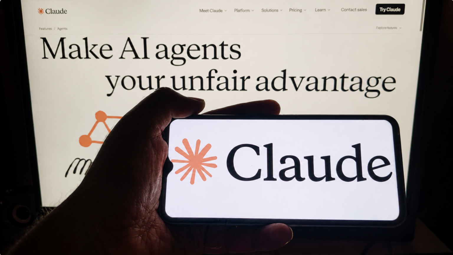 Claude AI Agent Deleted a Company’s Entire Database, Then Produced a Written Confession Listing the Safety Rules It Had Violated Smartphone displaying Claude logo held in front of a webpage promoting AI agents and tools.