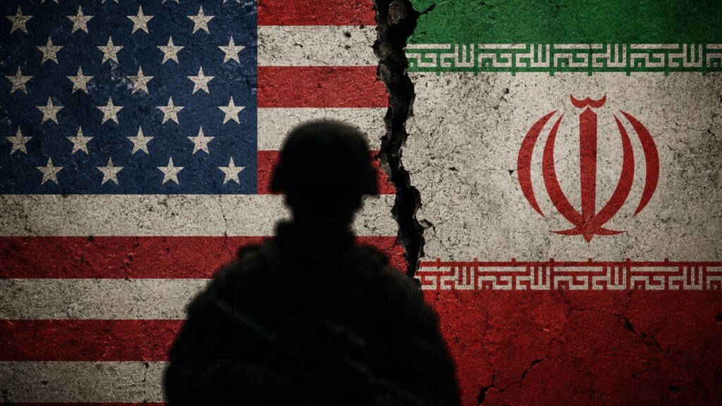 Cracked wall graphic split between the American and Iranian flags with the silhouette of a soldier standing in front.